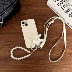 Camellia Flower and Puppy Pearl Charm Leather Crossbody Lanyard Phone Case for iPhone 14 Series