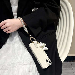 Camellia Flower and Puppy Pearl Charm Leather Crossbody Lanyard Phone Case for iPhone 16 Series